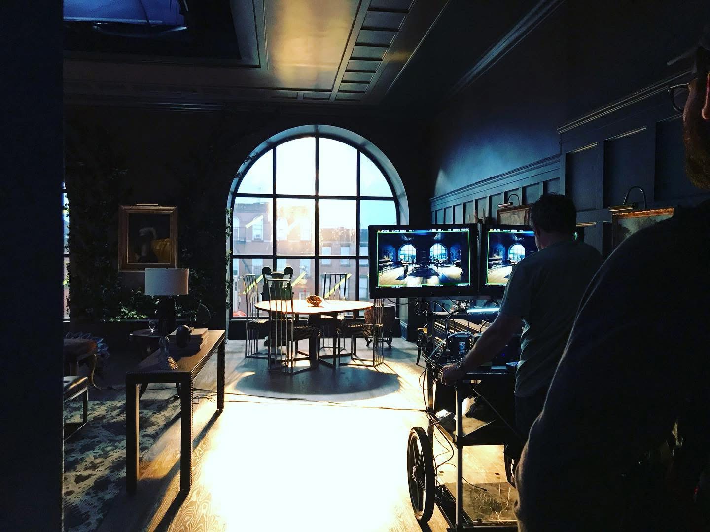 A real production set with a dramatic window, camera cart and monitors, photographed by Romanesh Reynoso